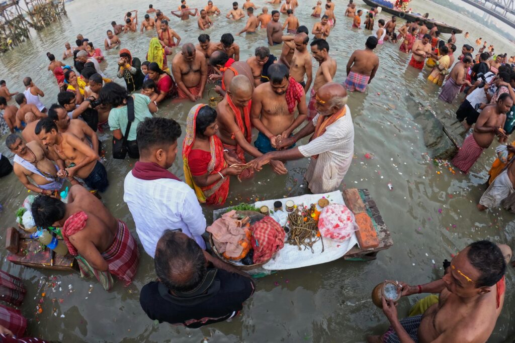 Devotees participate in a traditional ritual bathing ceremony on the banks of the Ganges River in Kolkata, India.